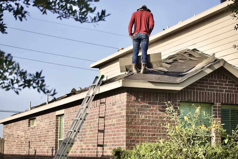 Professional roofer working on a residential roof in Leiperville